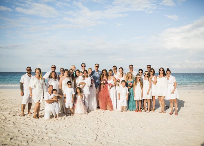 Guests in white, bride in pink