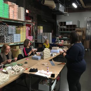Smock's Jen DeRoberts teaching gift wrapping workshop attendees how to make gift toppers at a gift wrapping workshop