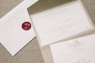 Custom pocketfold wedding invitations with matching monogram wax seal from Smock