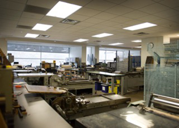 Cylinder and Vandercook presses stand in a beautiful row at A beautiful iron hand press awaits to be used at the Book Arts Program and Red Butte Press at the University of Utah.